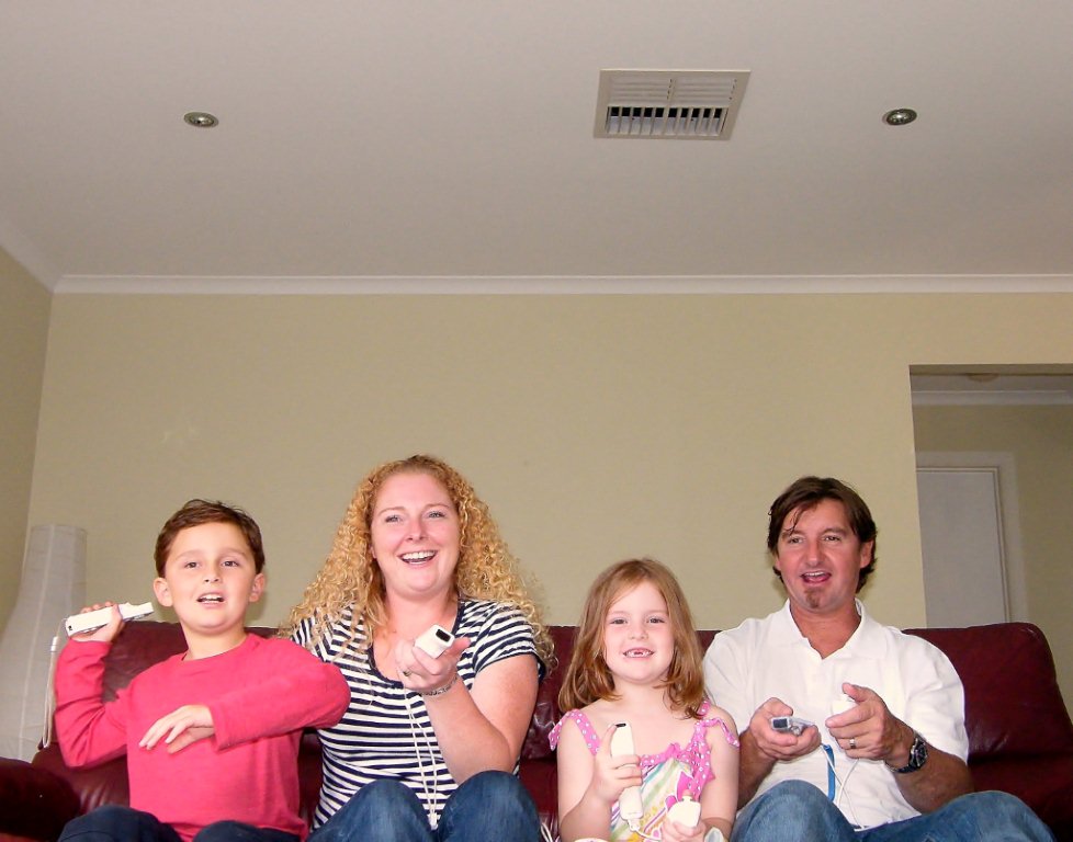 Family sitting down with vent above